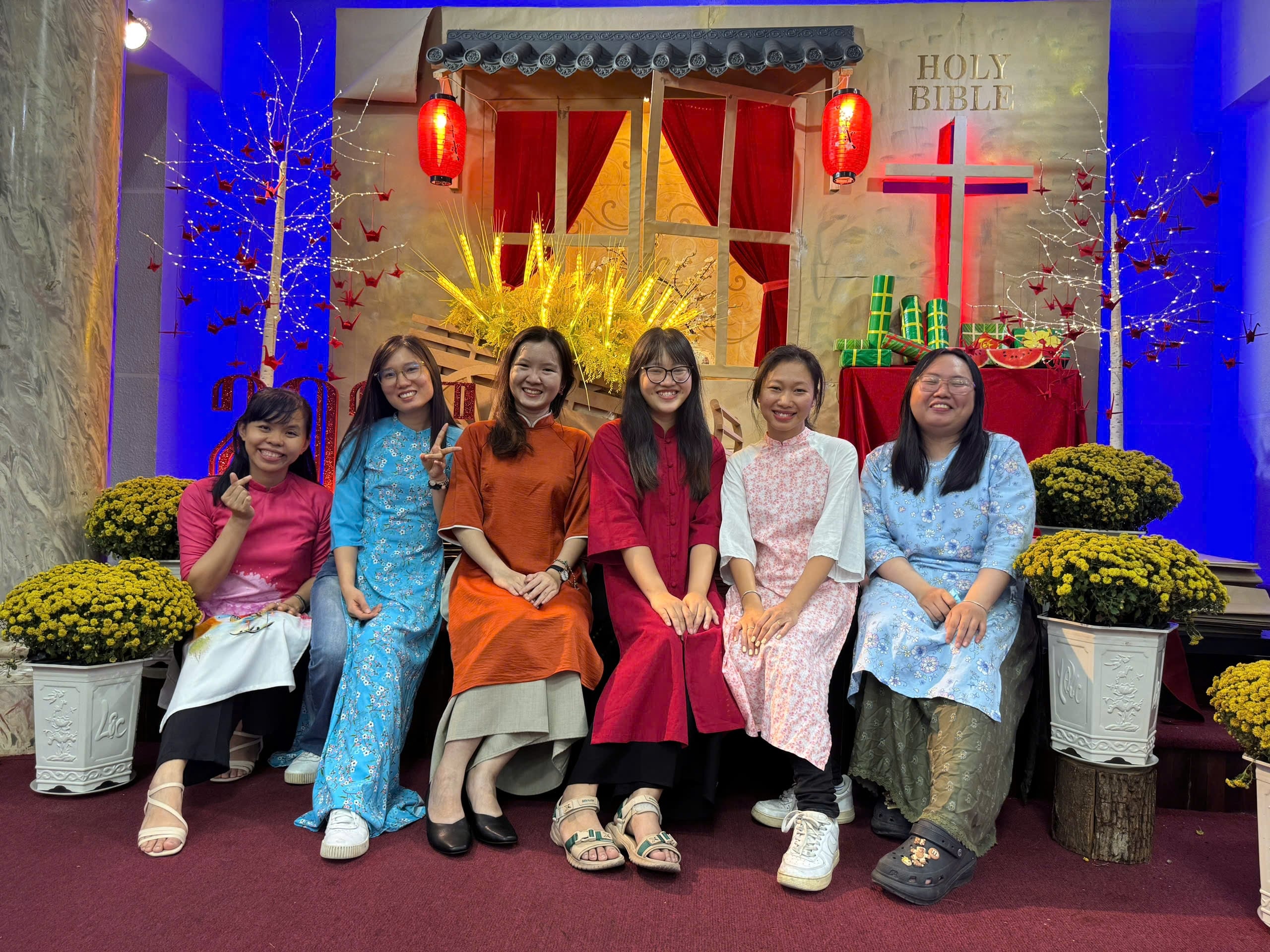 Women in traditional ao dai at a church gathering